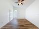 Spacious bedroom showcasing stylish wood-look floors and a charming arched window at 3317 Abigail Ct, New Port Richey, FL 34655