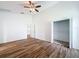 Open bedroom with wood-look flooring, and a view to a walk-in closet at 3317 Abigail Ct, New Port Richey, FL 34655