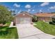 Charming exterior view of home featuring a garage, driveway, and manicured lawn at 3317 Abigail Ct, New Port Richey, FL 34655