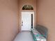 Inviting front entrance with white door, side window, and a stylish bench for relaxation at 3317 Abigail Ct, New Port Richey, FL 34655