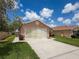 The exterior features a two-car garage with a neutral palette and tidy landscaping, offering curb appeal at 3317 Abigail Ct, New Port Richey, FL 34655