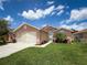 Charming single-Gathering home with lush green lawn, beautiful landscaping, and attached two-car garage at 3317 Abigail Ct, New Port Richey, FL 34655