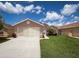 Charming single-Gathering home with lush green lawn, beautiful landscaping, and attached two-car garage at 3317 Abigail Ct, New Port Richey, FL 34655