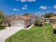 Charming single-Gathering home with lush green lawn, beautiful landscaping, and attached two-car garage at 3317 Abigail Ct, New Port Richey, FL 34655