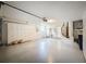 Garage with a painted concrete floor, overhead lighting, and storage cabinets at 3317 Abigail Ct, New Port Richey, FL 34655