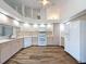 Open concept kitchen with tile floors, white appliances, and neutral paint at 3317 Abigail Ct, New Port Richey, FL 34655
