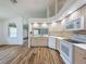 Bright kitchen featuring wood floors, light wood cabinetry, white appliances, and a window over the sink at 3317 Abigail Ct, New Port Richey, FL 34655
