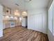 Open kitchen area featuring wood-look tile flooring and white appliances at 3317 Abigail Ct, New Port Richey, FL 34655