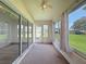 Enclosed lanai featuring sliding glass doors, neutral carpet, and a ceiling fan at 3317 Abigail Ct, New Port Richey, FL 34655