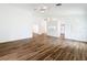 Open living space features beautiful wood flooring, neutral paint, an arched window and a kitchen view at 3317 Abigail Ct, New Port Richey, FL 34655