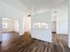 Open-concept floor plan featuring wood-look floors, white walls, and lots of natural light at 3317 Abigail Ct, New Port Richey, FL 34655
