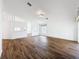 Open-concept living space boasts wood flooring, neutral paint, multiple rooms, and an arched window at 3317 Abigail Ct, New Port Richey, FL 34655