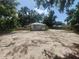 Large backyard featuring ample space, mature trees, and partial fencing, perfect for outdoor activities at 3415 N 51St St, Tampa, FL 33619