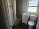 Bathroom features a vanity with storage, toilet, tile shower, and a window for natural light at 3415 N 51St St, Tampa, FL 33619