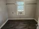 Bedroom with hardwood floors, neutral paint, and a window AC unit at 3415 N 51St St, Tampa, FL 33619