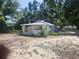Charming cottage-style home featuring a spacious front yard and mature trees at 3415 N 51St St, Tampa, FL 33619