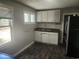 Functional kitchen with stainless steel refrigerator, updated cabinets, and wood look flooring at 3415 N 51St St, Tampa, FL 33619