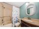 Bathroom featuring tub shower, vanity, toilet, and wicker framed mirror at 3841 Lanyard Ct # B, New Port Richey, FL 34652