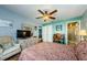 Bedroom with wood floors, ceiling fan and adjacent bathroom at 3841 Lanyard Ct # B, New Port Richey, FL 34652