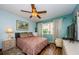 Cozy bedroom features wood flooring, a ceiling fan, and a window with natural light at 3841 Lanyard Ct # B, New Port Richey, FL 34652
