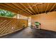 Spacious carport features a wooden lattice, storage area, and outdoor utility table at 3841 Lanyard Ct # B, New Port Richey, FL 34652