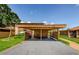 Assigned carport parking with well-manicured lawns on a sunny day at 3841 Lanyard Ct # B, New Port Richey, FL 34652
