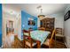 Charming dining room with wood table set and accent hutch near colorful wall art at 3841 Lanyard Ct # B, New Port Richey, FL 34652