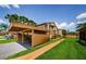 Exterior view of condo featuring carport, lush lawns and sidewalks at 3841 Lanyard Ct # B, New Port Richey, FL 34652