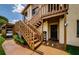 Exterior featuring wooden stairs, landscaping, and painted building at 3841 Lanyard Ct # B, New Port Richey, FL 34652