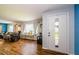 Inviting foyer featuring wood floors, a front door with glass accents, and a view of the living room at 3841 Lanyard Ct # B, New Port Richey, FL 34652