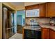 Well-maintained kitchen with stainless steel appliances and a pass through to other rooms at 3841 Lanyard Ct # B, New Port Richey, FL 34652
