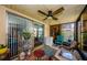 Relaxing screened-in patio with ceiling fan and vibrant decor at 3841 Lanyard Ct # B, New Port Richey, FL 34652