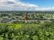 Aerial view showing a home nestled amongst green trees and foliage in a quiet suburban neighborhood at 4082 Watson Dr, New Port Richey, FL 34655