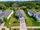 Aerial view of a light colored home with green lawn and treed backyard at 4082 Watson Dr, New Port Richey, FL 34655