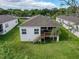 Aerial view of the backyard featuring a wooden deck, a well maintained lawn and rear building elevation at 4082 Watson Dr, New Port Richey, FL 34655