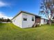 Grassy backyard with screened in porch and wood deck for peaceful outdoor living at 4082 Watson Dr, New Port Richey, FL 34655