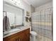 The neutral bathroom includes vanity, tile floors, and shower with a shower curtain at 4082 Watson Dr, New Port Richey, FL 34655