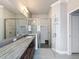 The neutral bathroom includes a double vanity, tile floors, and seamless glass shower at 4082 Watson Dr, New Port Richey, FL 34655