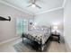The light and bright bedroom includes window shutters, wood look floors, and neutral walls at 4082 Watson Dr, New Port Richey, FL 34655