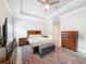 This spacious bedroom features tray ceilings, neutral paint, and wood furnishings at 4082 Watson Dr, New Port Richey, FL 34655