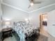 Bedroom featuring a queen bed, bedside tables with lamps, ceiling fan, and a doorway to another room at 4082 Watson Dr, New Port Richey, FL 34655
