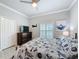 Bedroom with window, ceiling fan, closet, dresser, and modern decor for a comfortable living space at 4082 Watson Dr, New Port Richey, FL 34655