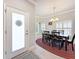Inviting dining room with natural light, elegant chandelier, and dining set at 4082 Watson Dr, New Port Richey, FL 34655