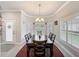Dining room view showcases natural light, an elegant chandelier and a dining set at 4082 Watson Dr, New Port Richey, FL 34655