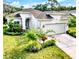 Charming single-story home boasting a two-car garage, manicured lawn, and lush landscaping at 4082 Watson Dr, New Port Richey, FL 34655