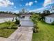 Lovely home featuring a well-kept lawn, mature trees, and a wide driveway leading to an attached garage at 4082 Watson Dr, New Port Richey, FL 34655