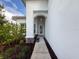 Inviting front entrance with a covered porch, stylish door, and well-maintained landscaping leading to the home at 4082 Watson Dr, New Port Richey, FL 34655