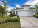 Charming single Gathering home featuring a two car garage, beautiful landscape and a freshly painted white exterior at 4082 Watson Dr, New Port Richey, FL 34655