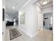 Inviting hallway connects the living area to a bedroom with neutral decor and tile floors at 4082 Watson Dr, New Port Richey, FL 34655