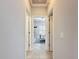 Hallway view into the bedroom with neutral walls and tile floors at 4082 Watson Dr, New Port Richey, FL 34655